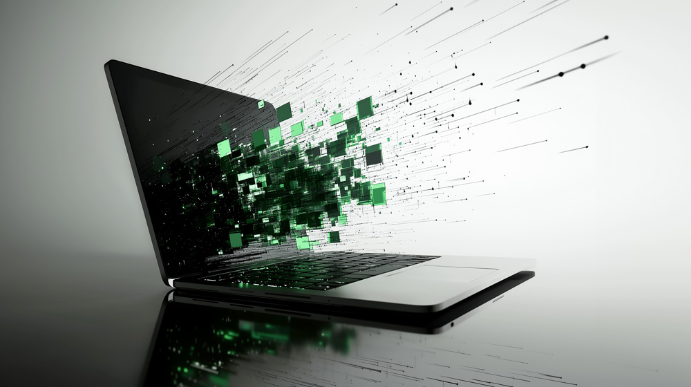Computer with green elements flying off the screen.